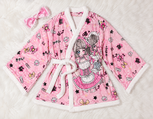 MBCosplay kawaii pink anime fleece robe featuring cute bow details, Japanese-inspired artwork, plush white trim, and soft cosy fabric displayed as a flat lay loungewear product image.