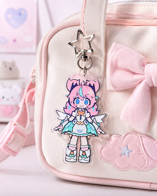 Pink character keychain on a pink bag with a bow