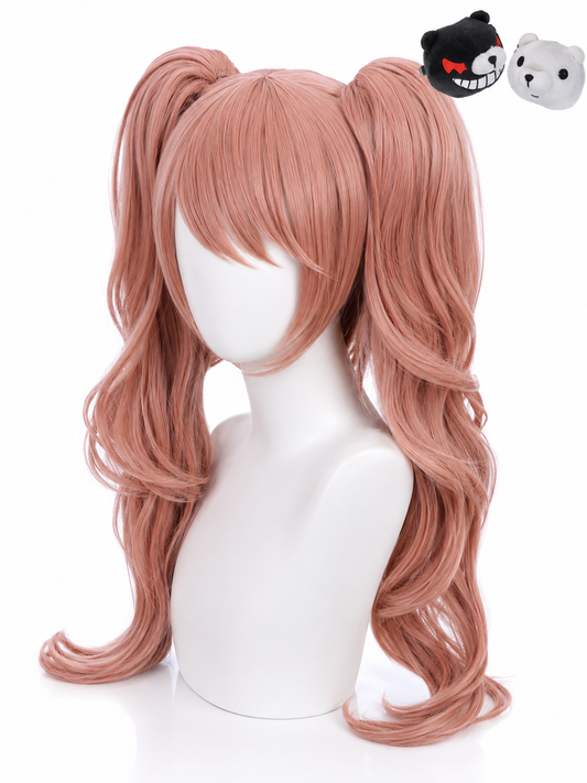 A long, wavy pink wig with high double ponytails is displayed on a white mannequin head against a white background. Two small plush toy heads are visible in the upper right corner, one black with a red bow and one white.