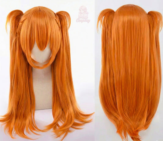Orange wig with twin tails on a mannequin head against a white background