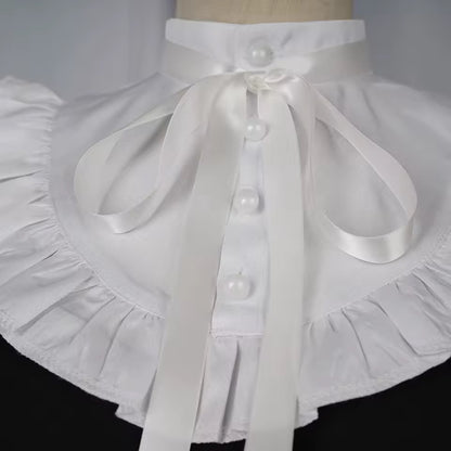 White apron with a large bow and buttons on a mannequin against a white background