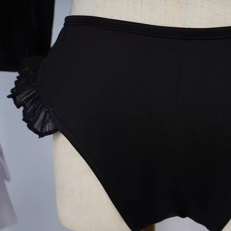 Black high-waisted bikini bottom on a mannequin with sheer mesh trim.