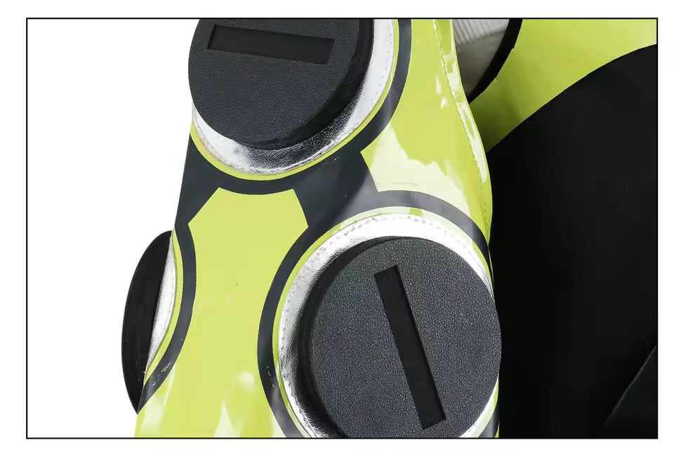 Close-up of a green and black object with circular designs on a white background