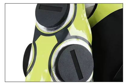 Close-up of a green and black object with circular designs on a white background