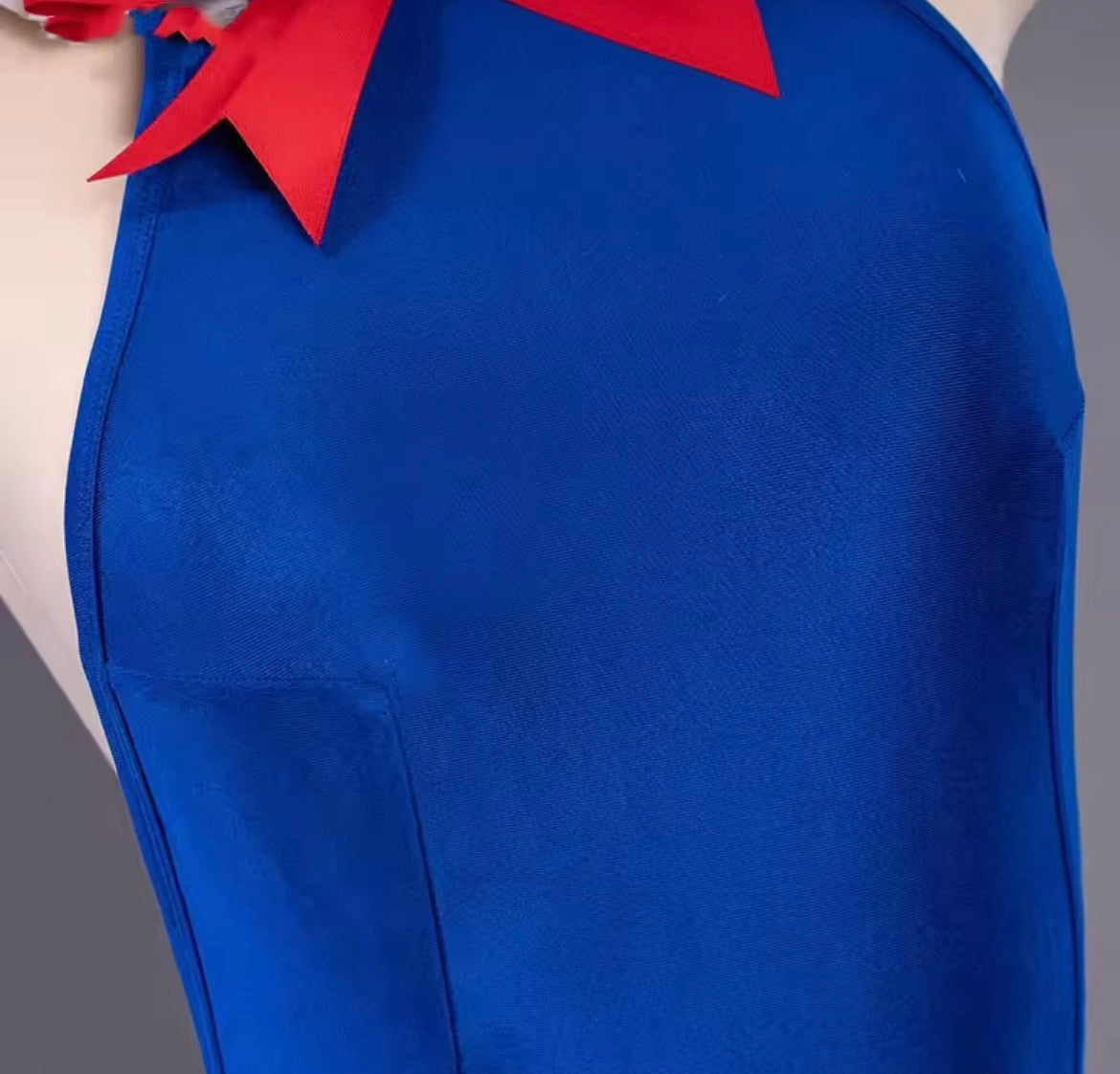 Blue apron with red collar on a neutral background