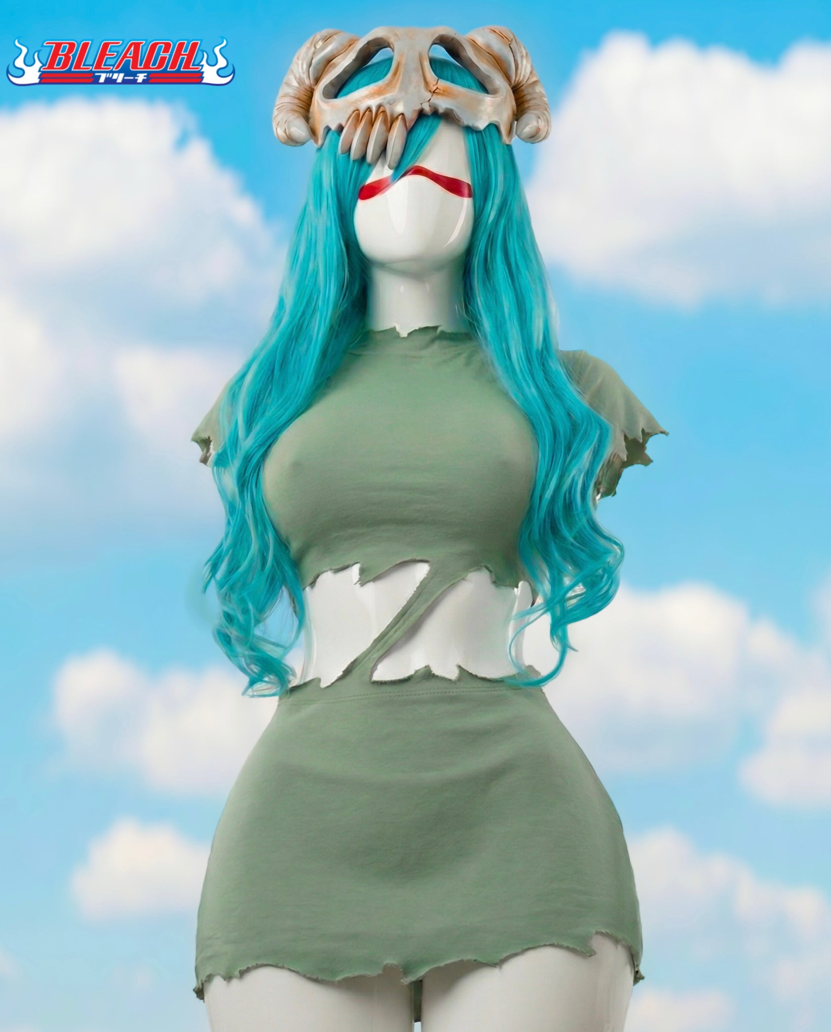 Mannequin with blue hair and green dress against a cloudy sky background