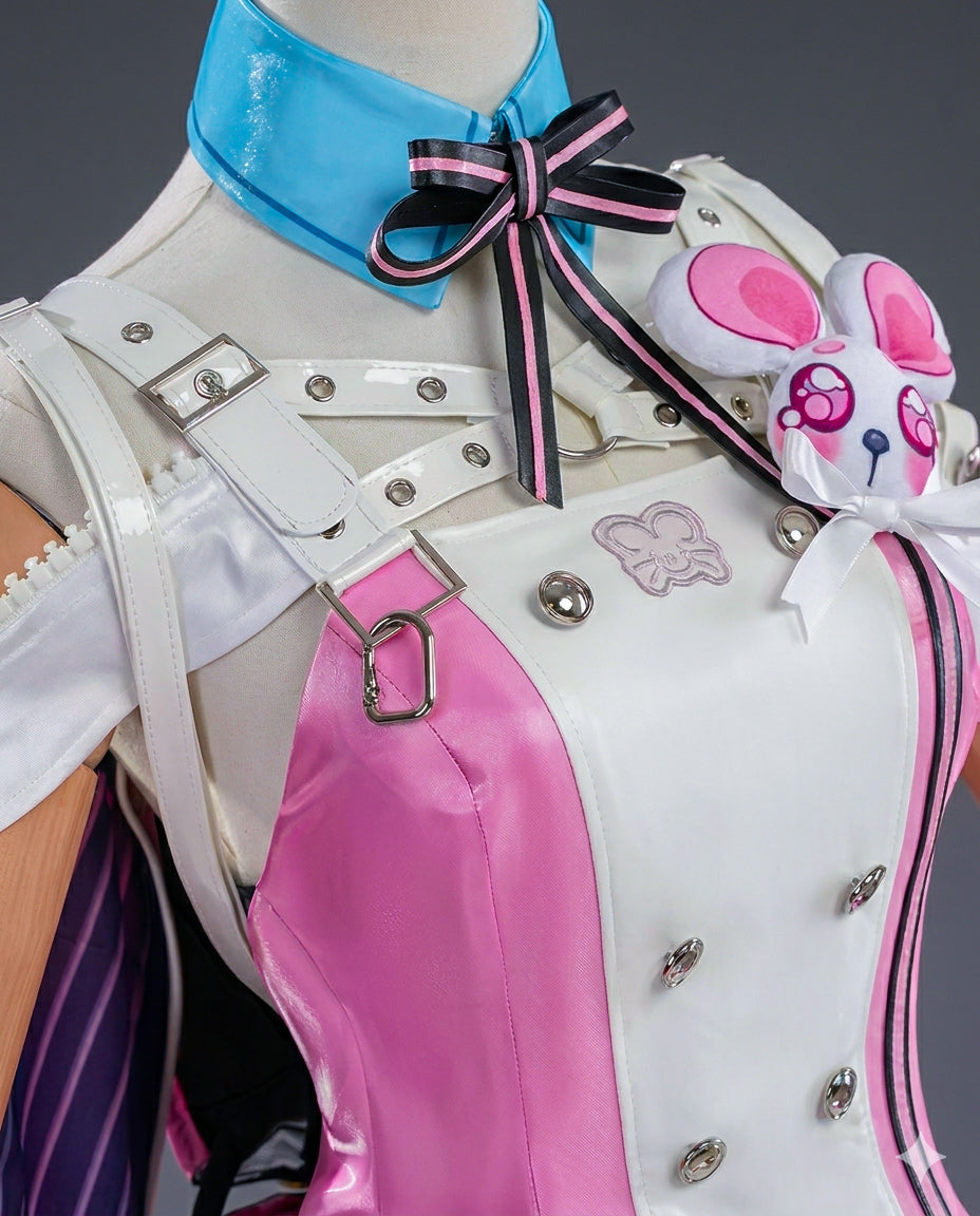 Close-up of a character costume with pink and white design, blue bow, and decorative elements.