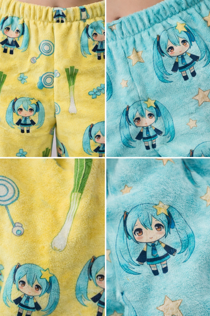 Close up detail of Hatsune Miku chibi pyjama bottoms in yellow and blue showing soft fleece fabric texture and all over anime character print pattern