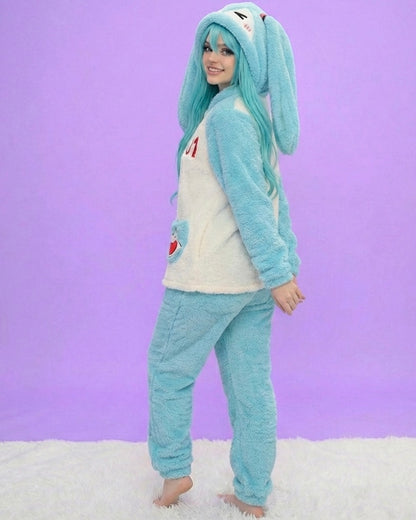 Person wearing a blue bunny onesie against a purple background