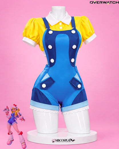 Front view of Juno's Overwatch 2 Hello Kitty cosplay with yellow blouse and blue overall shorts