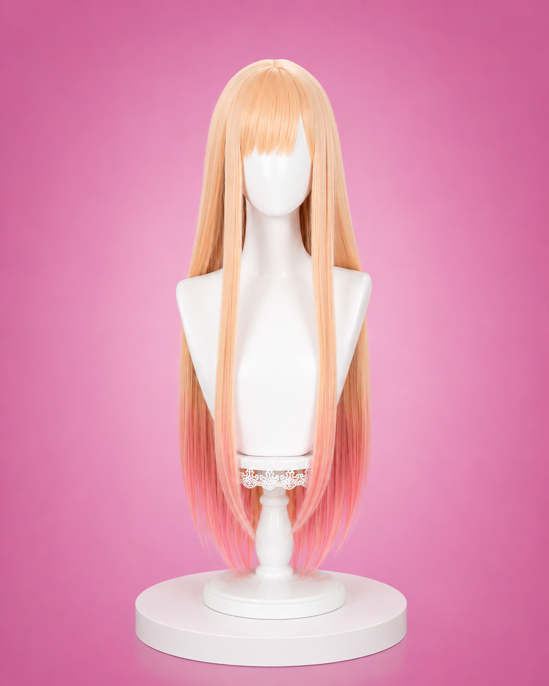 Blonde wig on a mannequin head against a pink background