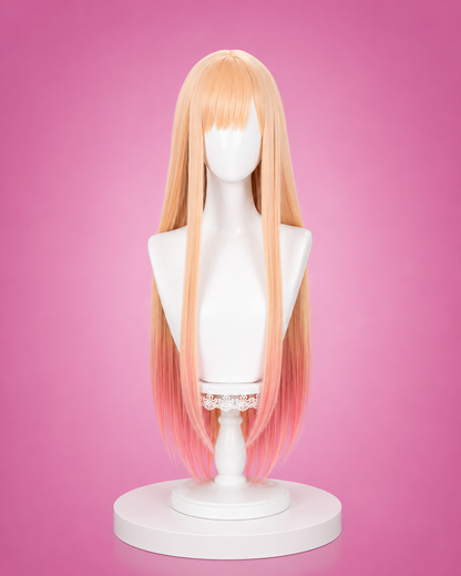 Blonde wig on a mannequin head against a pink background