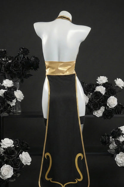 Mannequin wearing a black and gold dress with floral arrangements on a dark background
