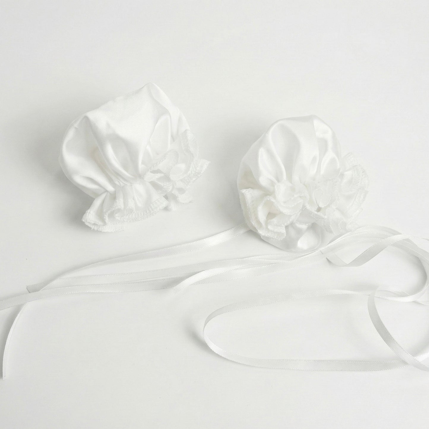 Close-up view of the white ruffled ox-horn hair accessories with satin ribbons for the Chun-Li set.