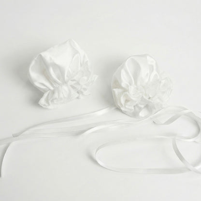 Close-up view of the white ruffled ox-horn hair accessories with satin ribbons for the Chun-Li set.