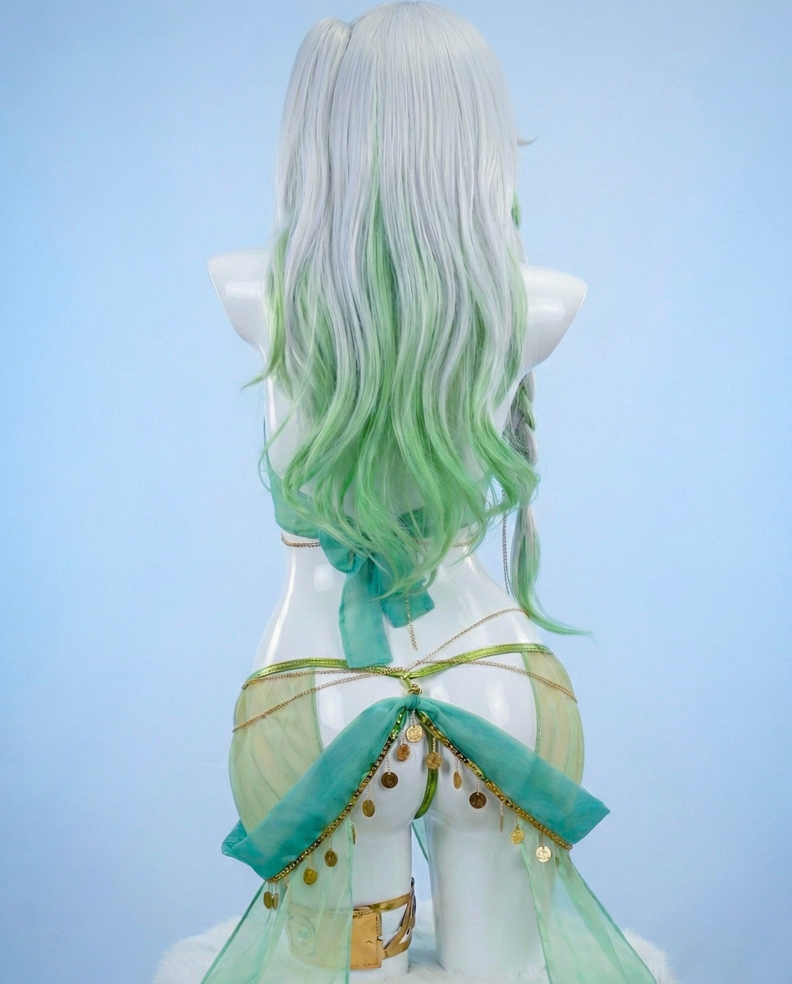 Mannequin with green and white hair and a green outfit on a light blue background