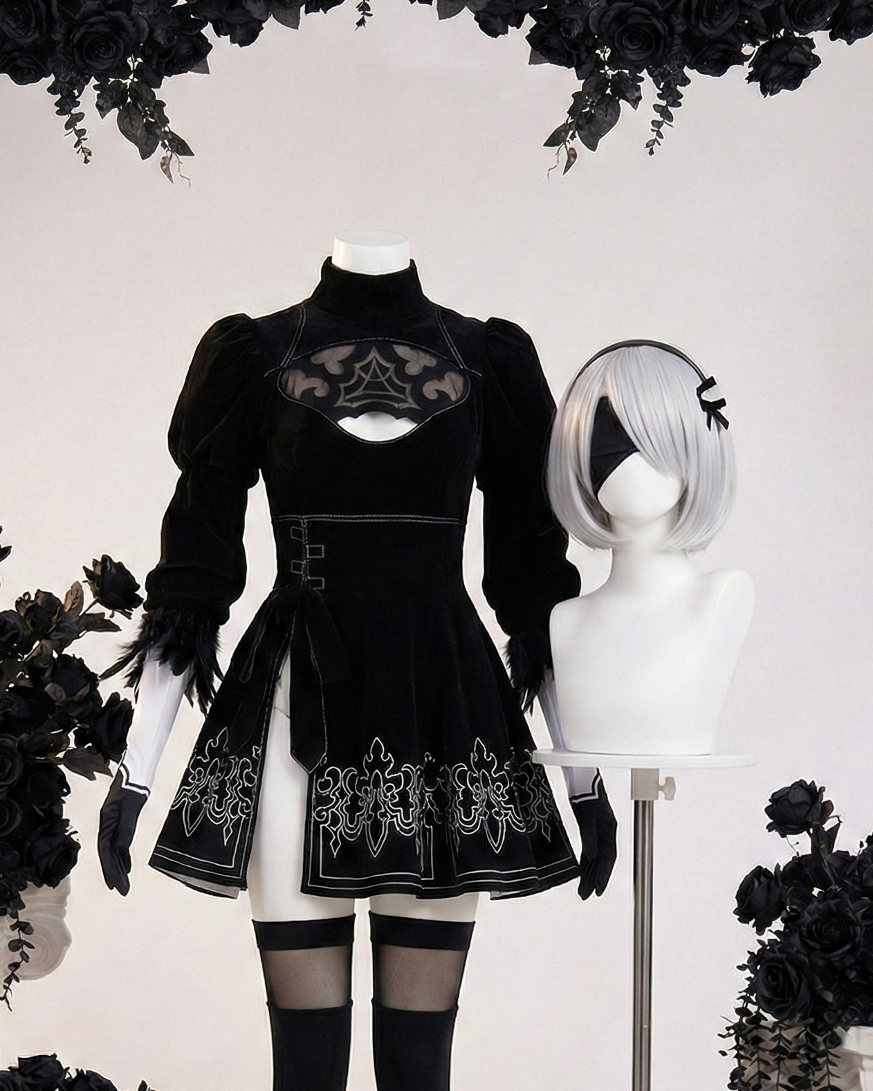 Front view of the premium 2B cosplay featuring a black velvet dress with a chest keyhole, silver embroidery, and feathered cuffs alongside a silver bob wig