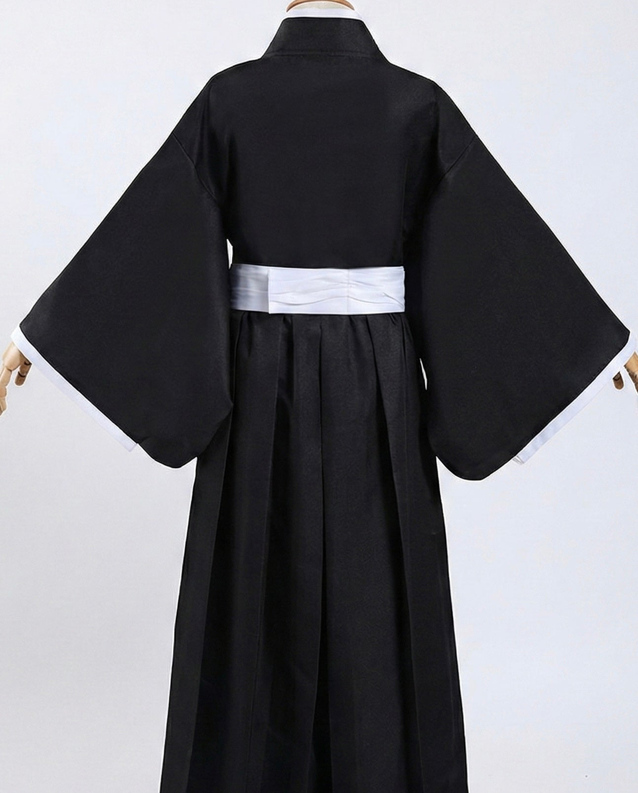 Black kimono with a white belt on a white background