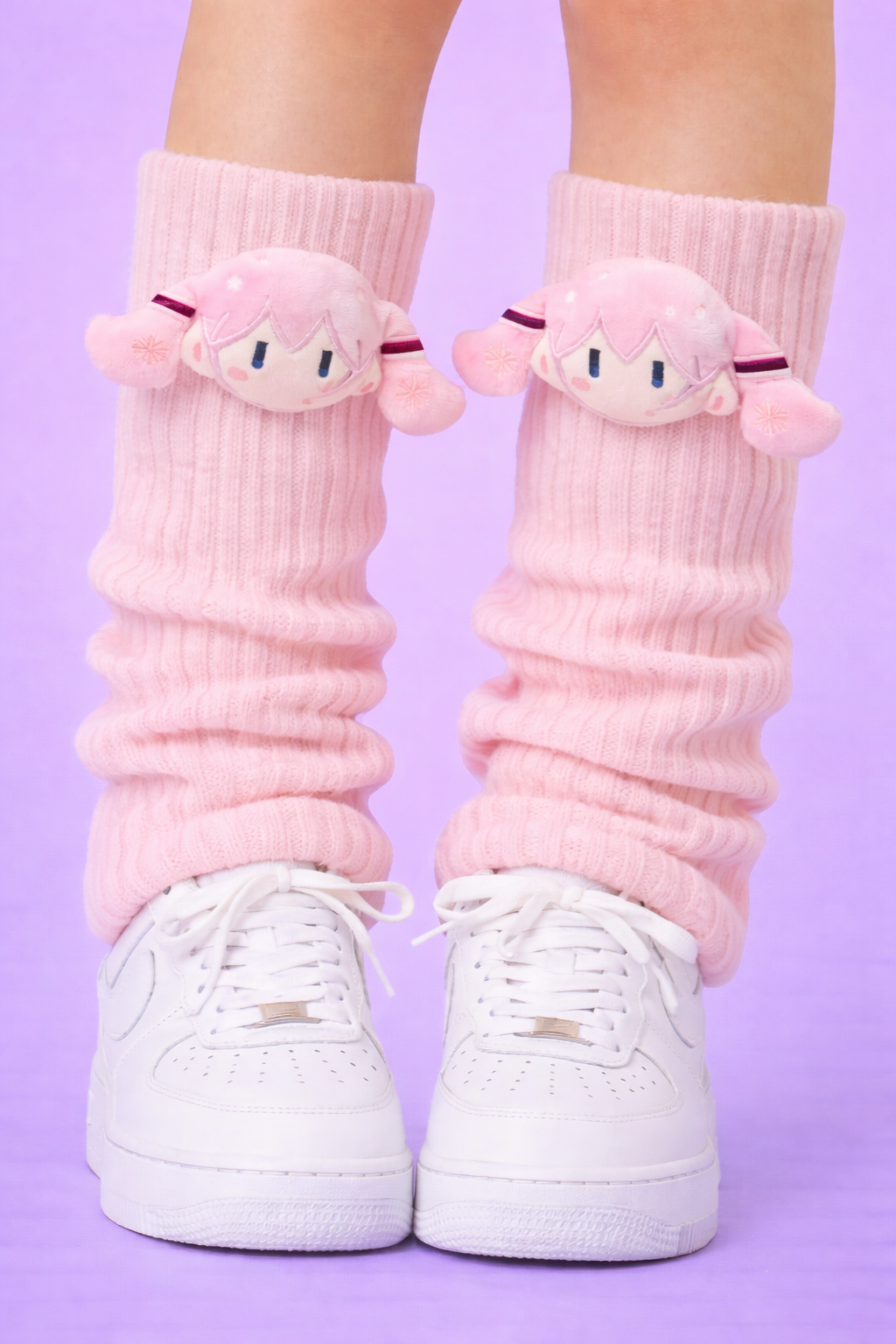 Pink socks with cartoon character faces worn with white sneakers on a purple background