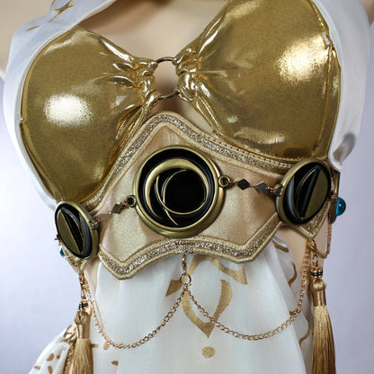 Close-up detail of the metallic gold and black waist armor piece, showcasing crescent moon motifs, textured gold fabric, and hanging gold chains with tassels.