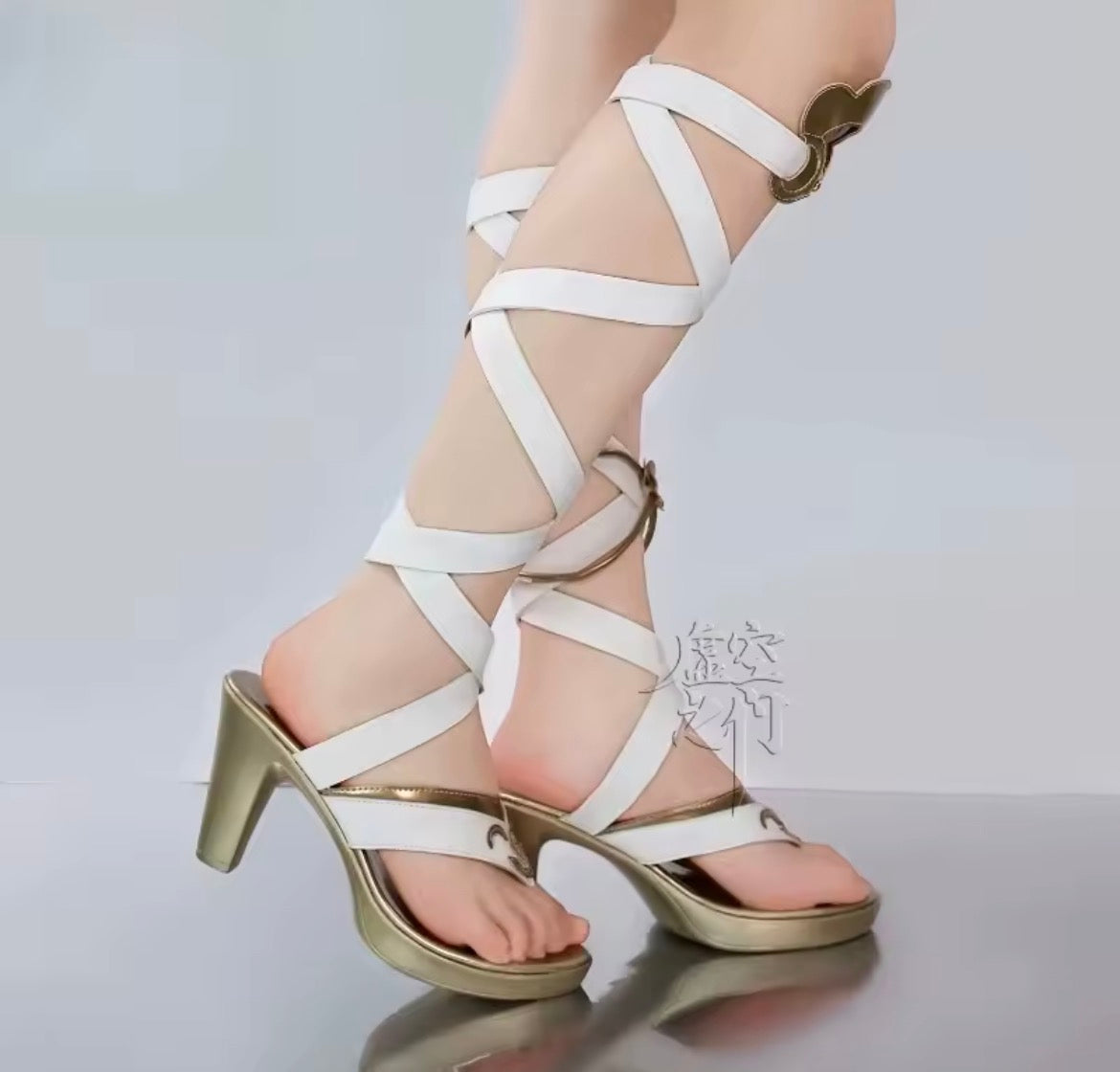 Model wearing the IUNO/LUNO white and gold strappy cosplay sandals, featuring a wrap-around leg design, gold hardware accents, and a metallic block heel