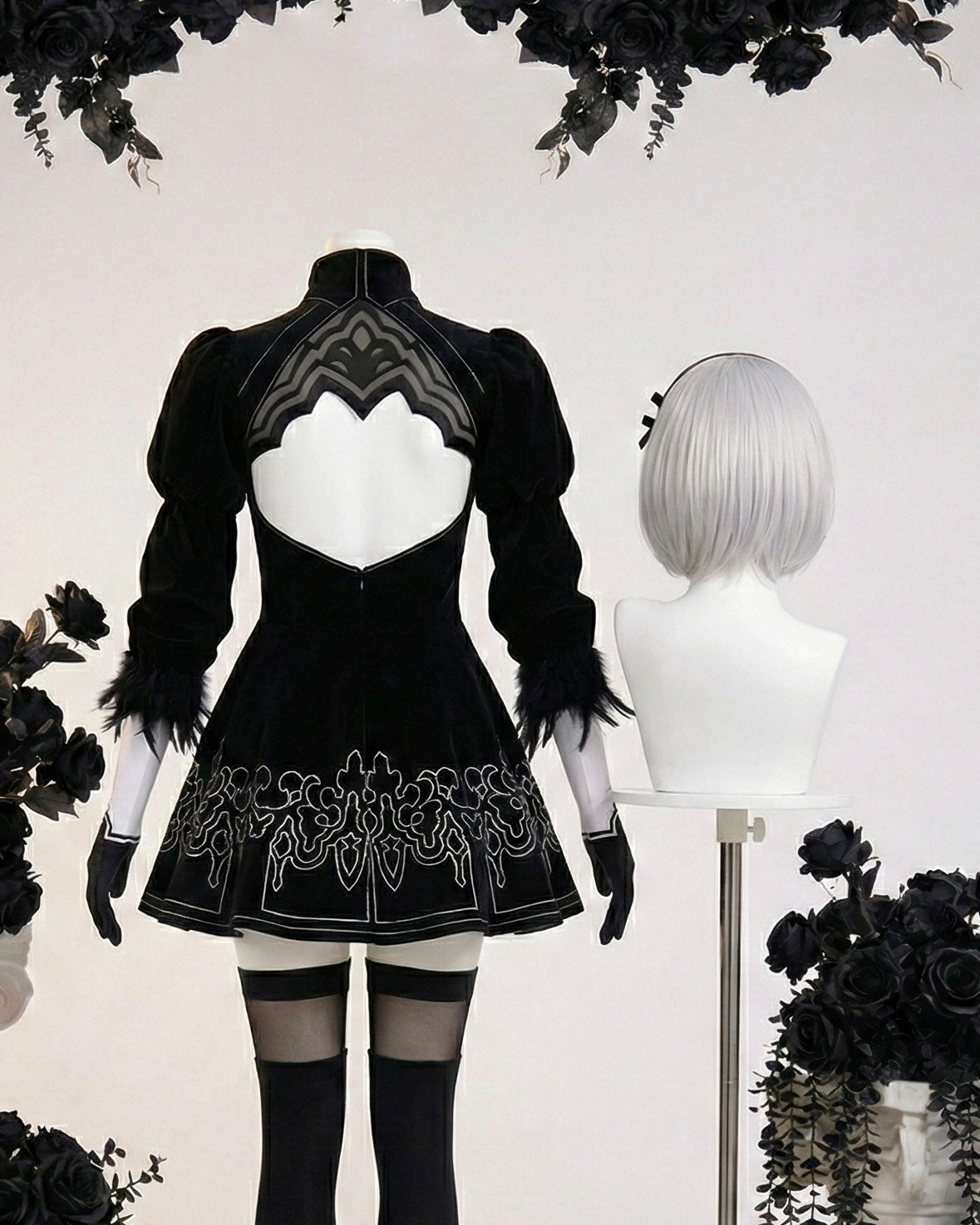 Rear view of 2B dress showing the heart-shaped open back and silver embroidery