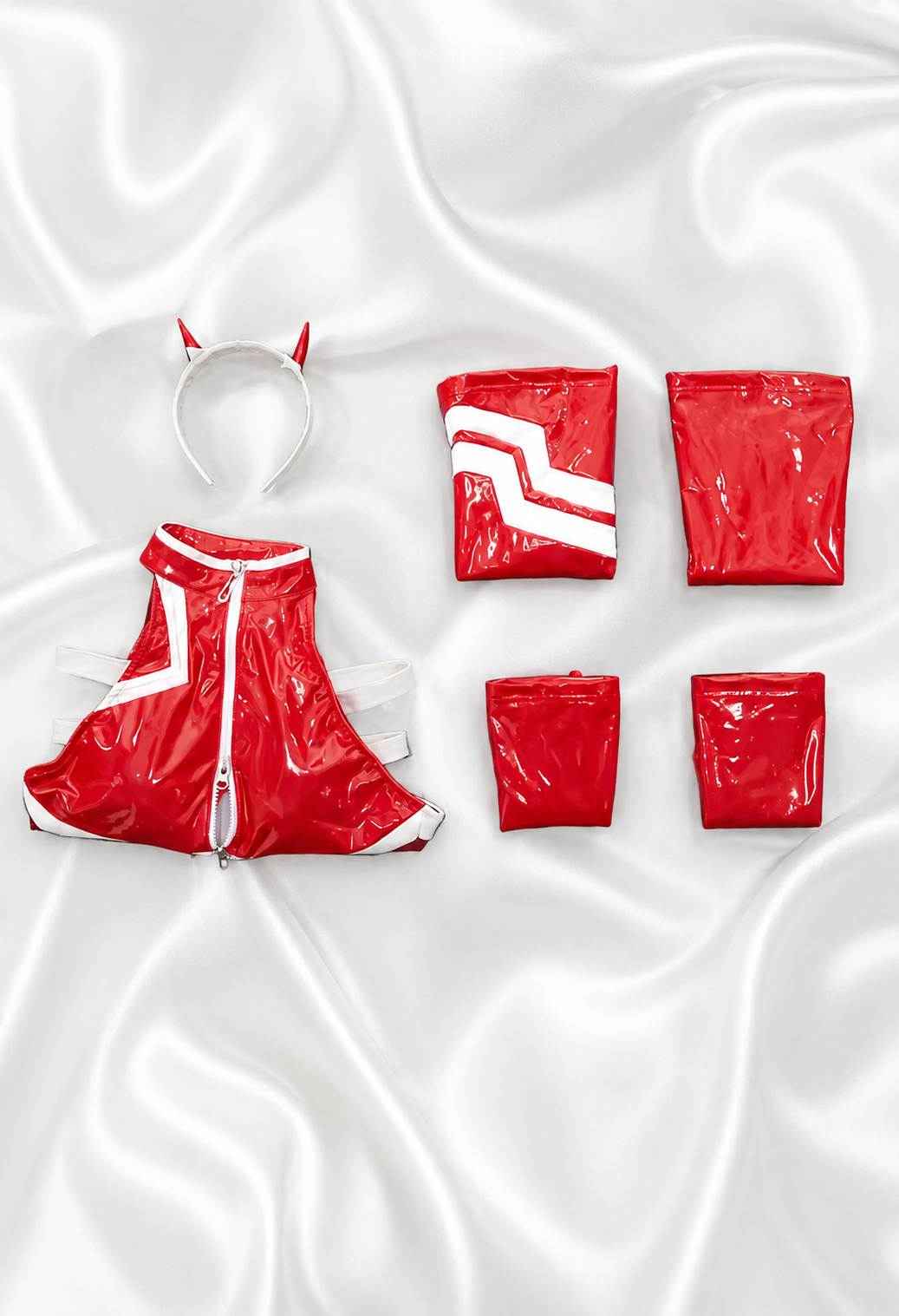 Red raincoat and matching pouches on a white fabric background