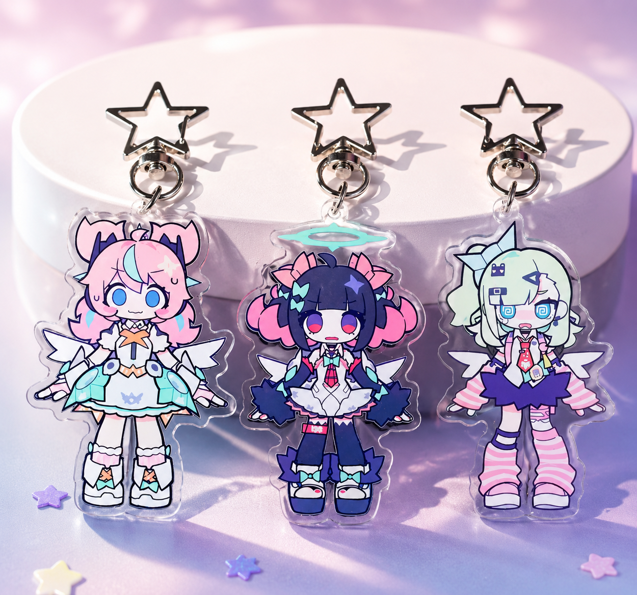 Three colorful character charms on a stand with a star design.